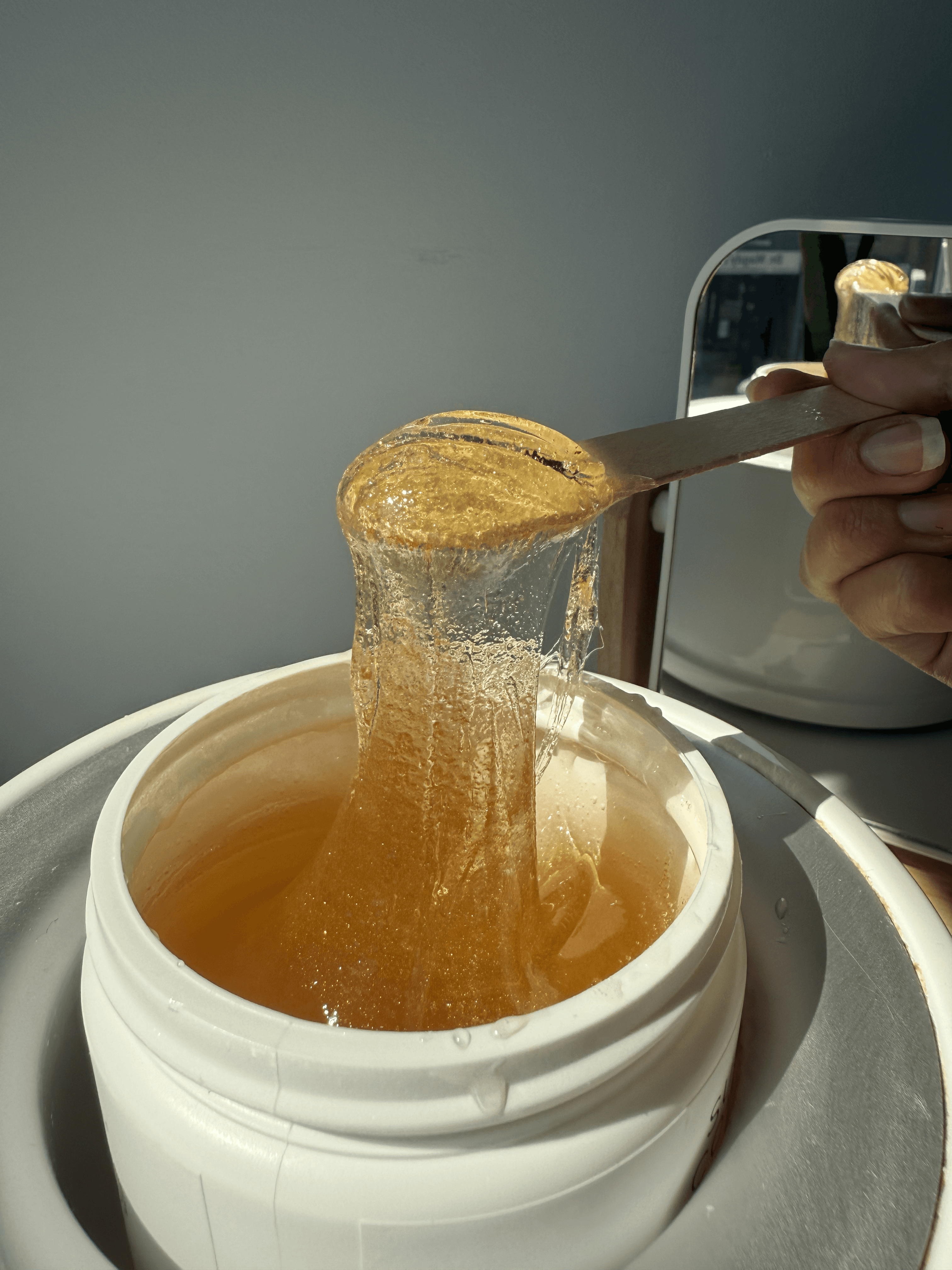Sugar paste being applied during a sugaring session